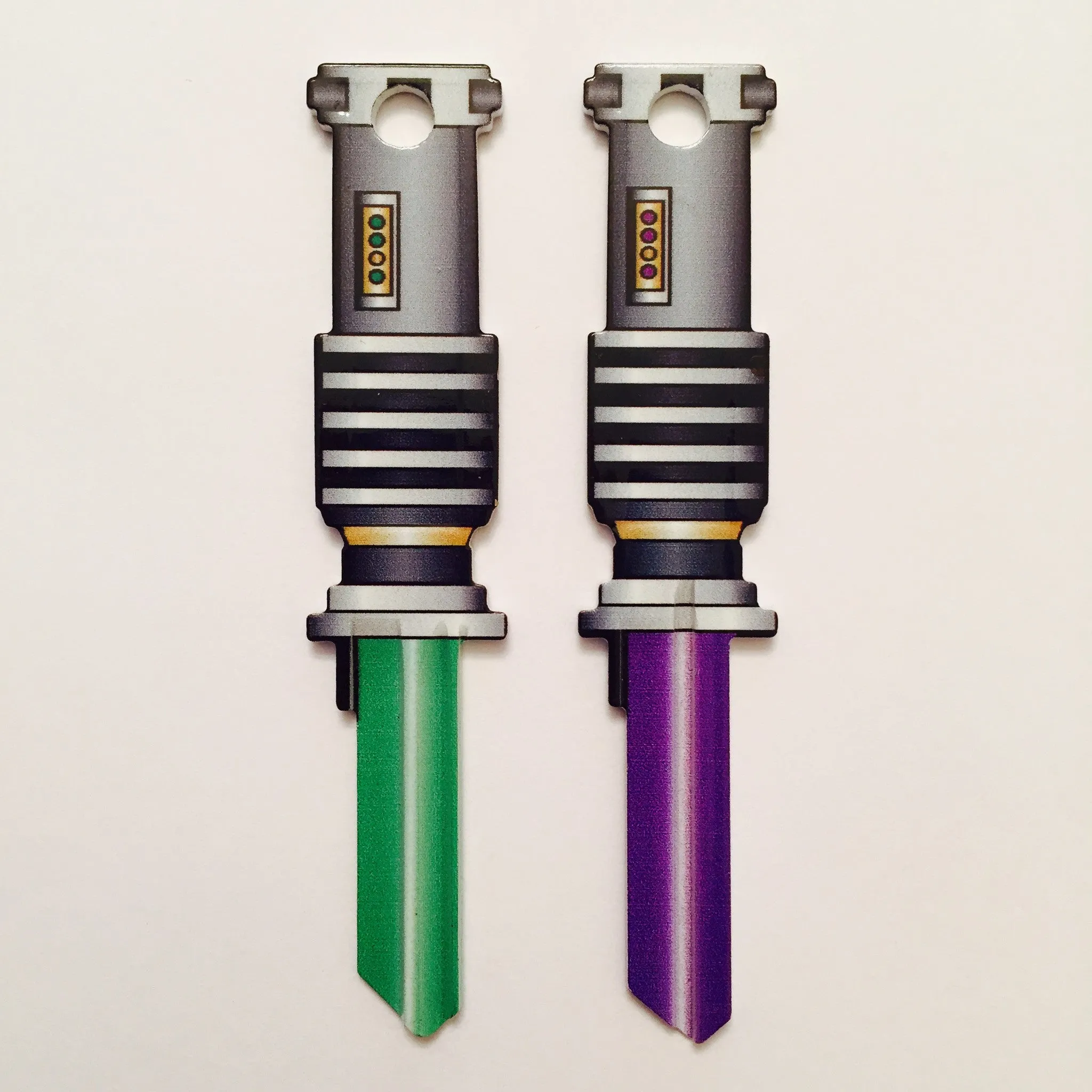 2 Green and Purple Light Saber Shaped Space Keys